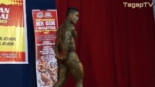 Malaysian pro-bodybuilder posing in thong