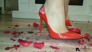 High heels crushing red rose