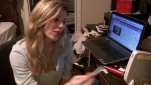 BEAUTIFUL BLONDE GIRL SMOKING A CIGARETTE IN FRONT OF HER LAPTOP COMPUTER