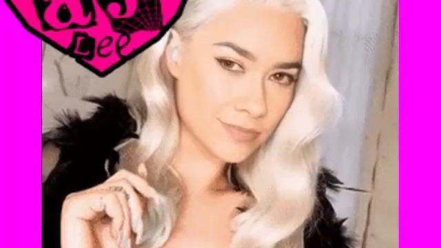 AJ Lee shows her blonde hair wig with chin mole