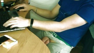 Teen boy jerking off by the desk while working online