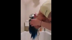 Washing blue hair over tub