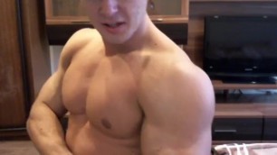 Russian bodybuilder and webcam model MTi poses and licking his muscle
