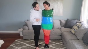 Girl is mummified in multi-colored duct tape and can't get loose